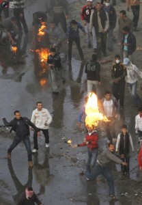 Egyptian anti-government protesters throw Molotov cocktails